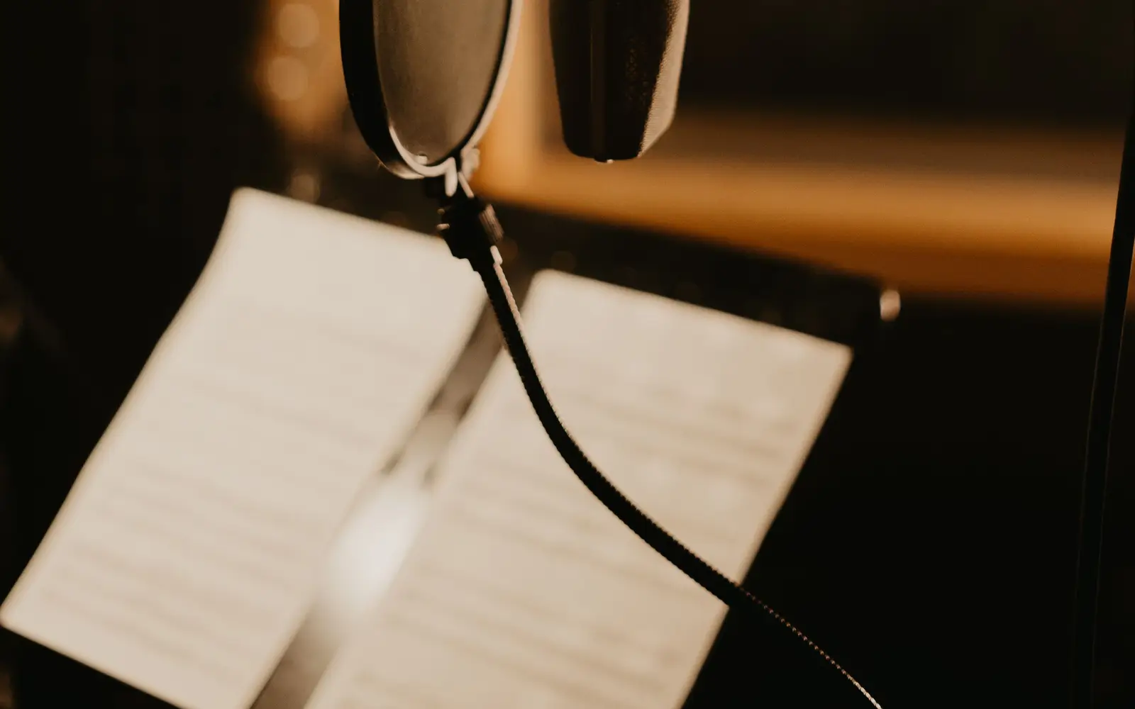A studio microphone in a warm booth, standing in for voice AI agents